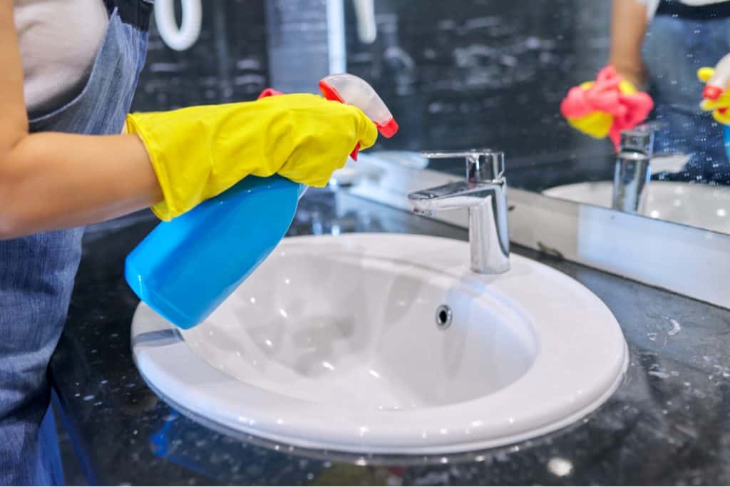 woman cleaning sink