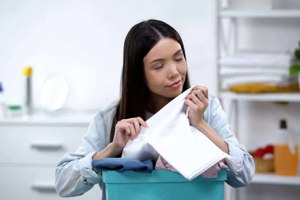 woman smelling fresh clean clothes