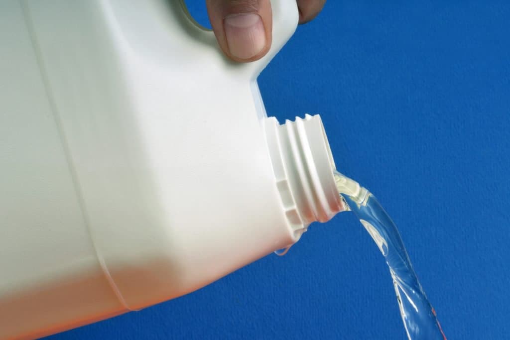 bleach being poured out of bottle