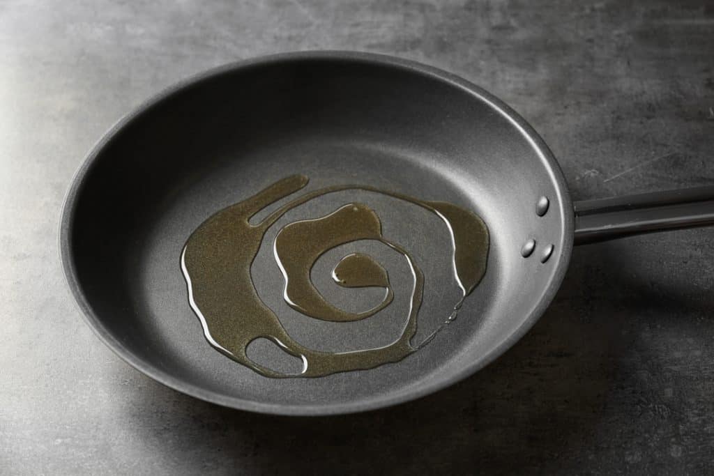 ceramic non-stick pan with a drizzle of oil