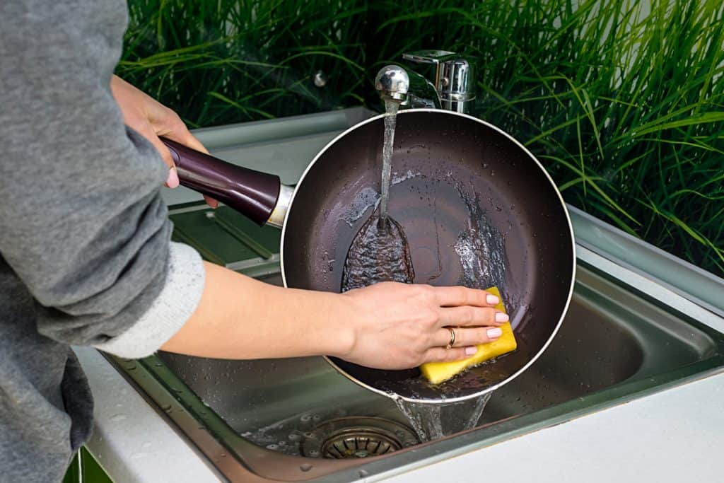 washing calphalon pan under water